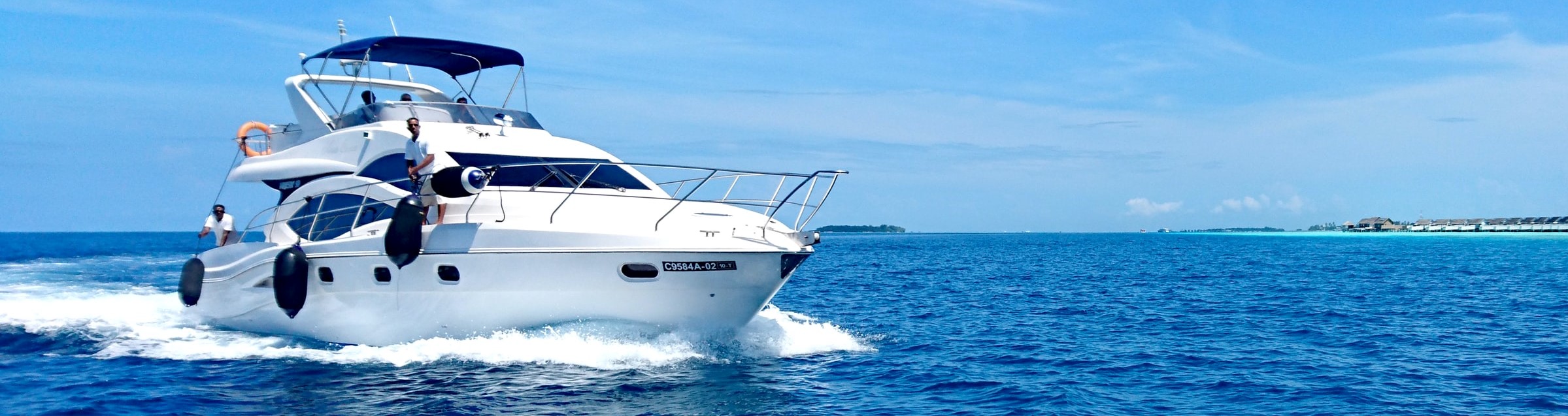 A yacht underway with fenders on the side.  Ready for docking.